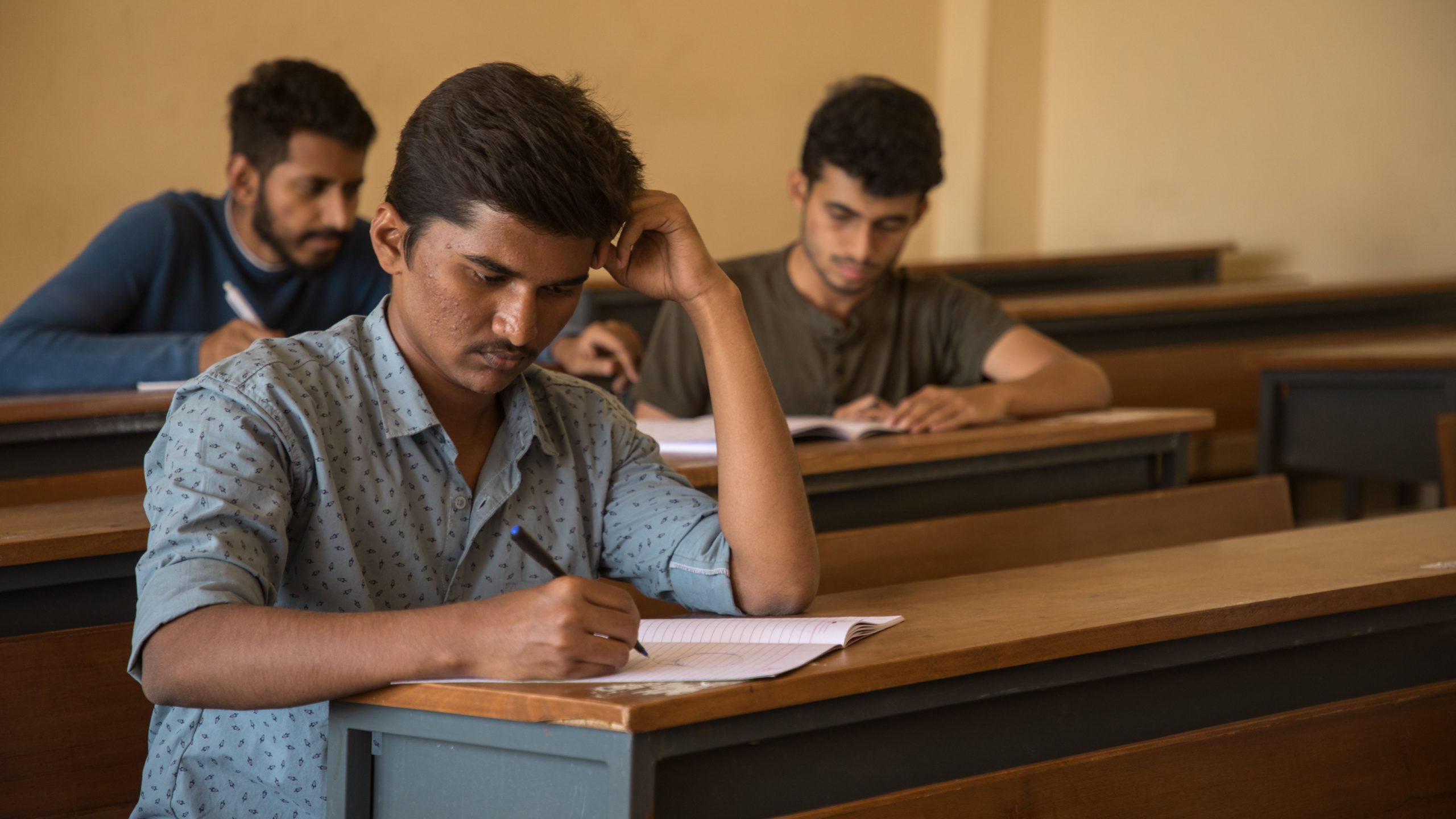 Medical students taking their USMLE Step 1 exam in a classroom.